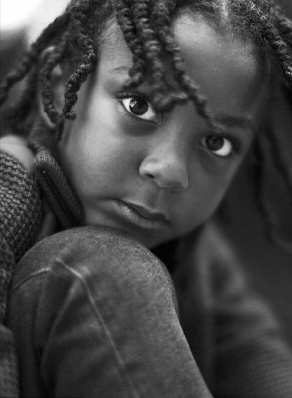 Black-and-white portrait of an adolescent looking toward the camera